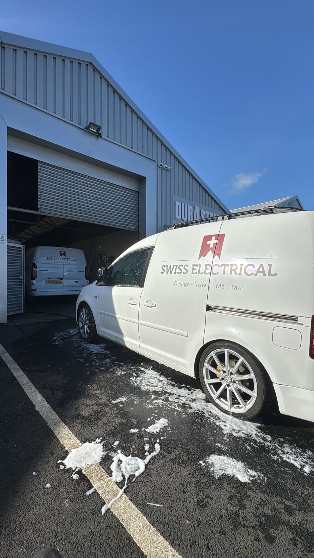 Swiss Electrical on the job — vans washed between jobs