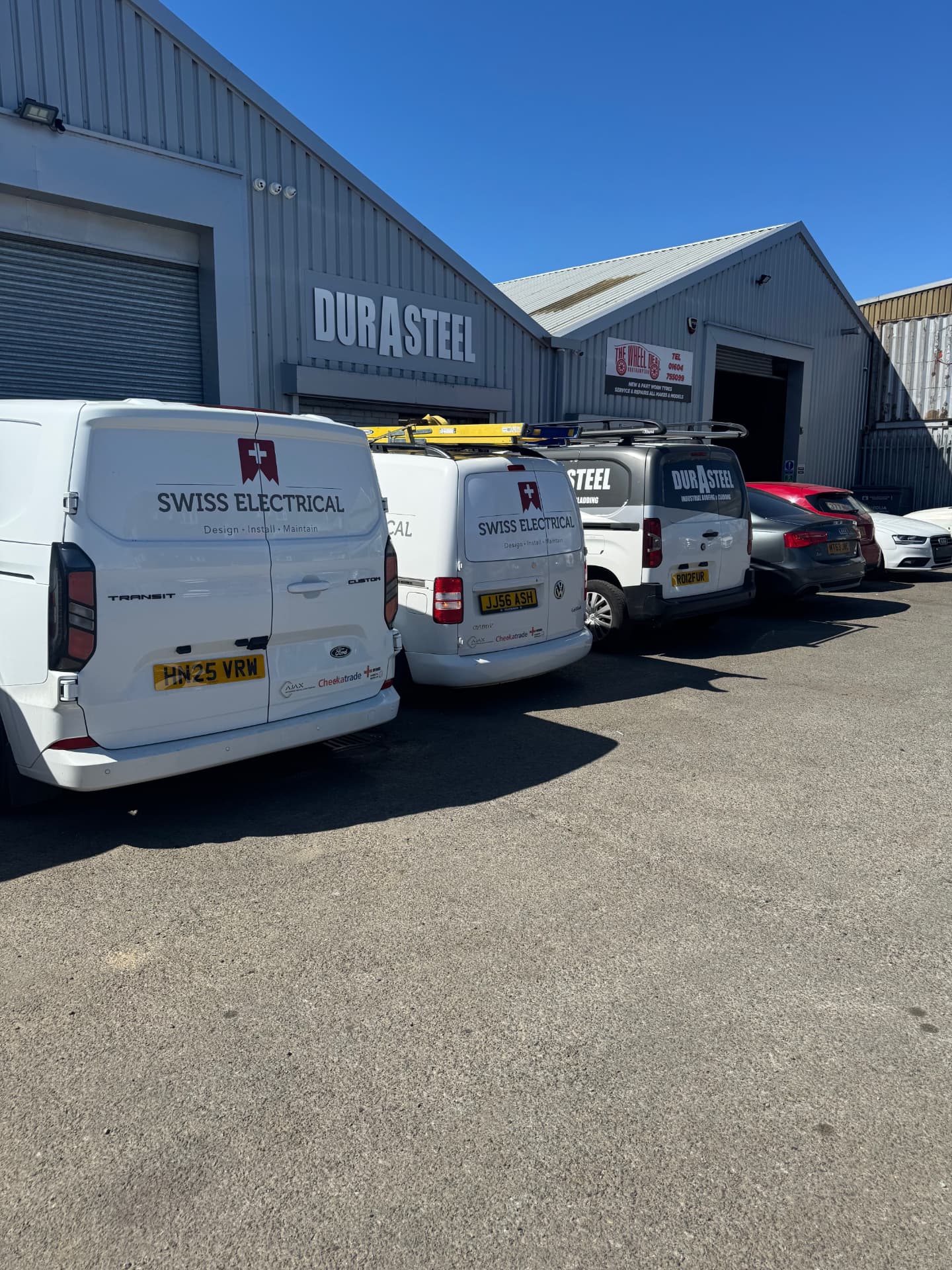 Swiss Electrical on the job — the vans, ready to go