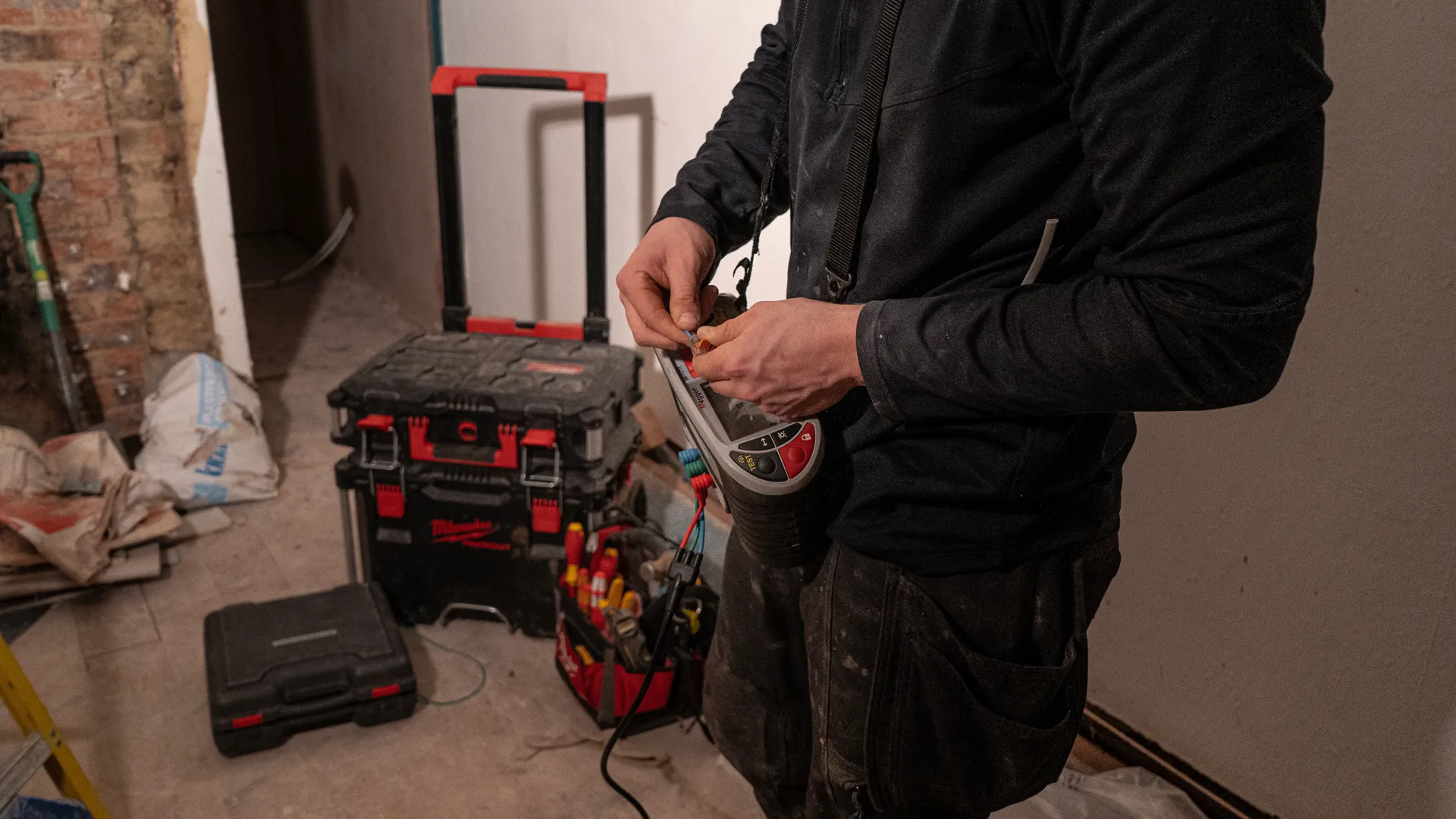 Swiss Electrical electrician testing circuits during an emergency call-out in Northampton